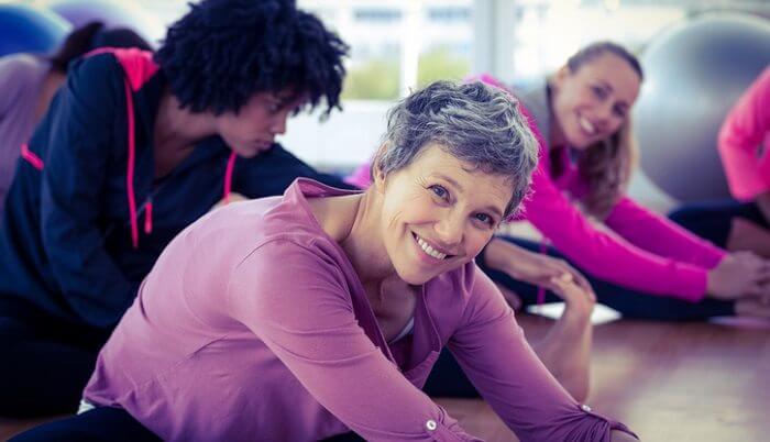 happy women stretching in gym