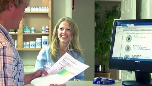 receptionist with client reading ZYTO report