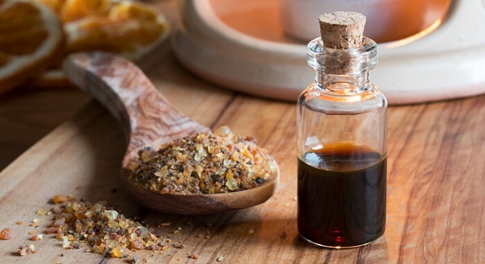 A bottle of myrrh essential oil with myrrh resin