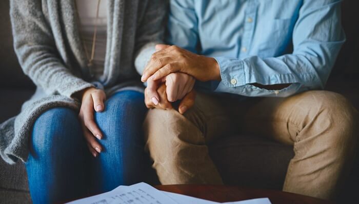 Closeup shot of a couple holding hands in comfort