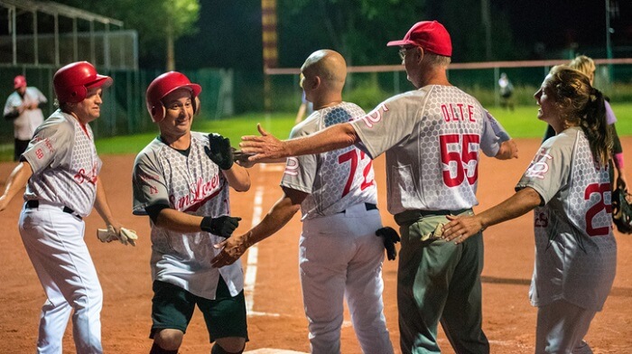 softball team high fiving after score