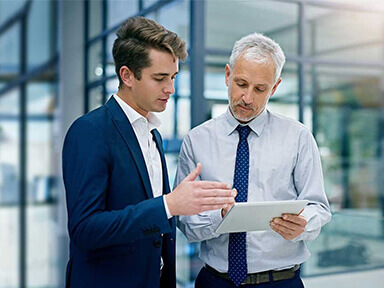 businessmen looking a tablet screen in office