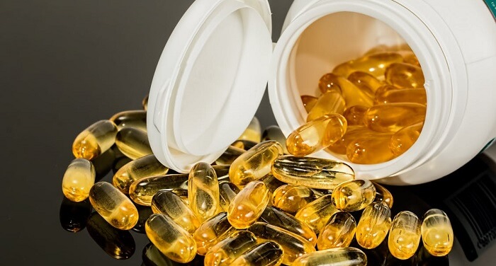 open bottle of vitamin e pills