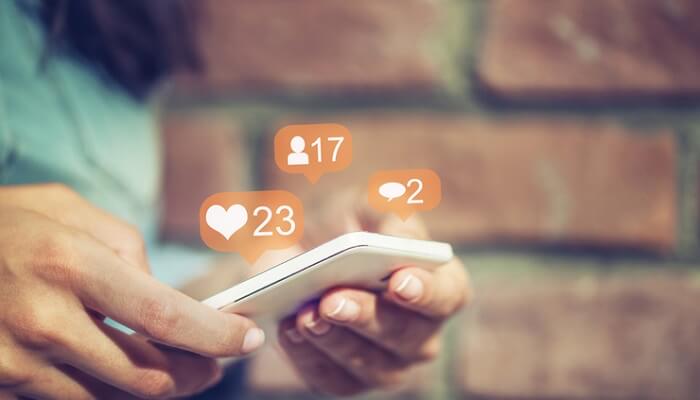 woman looking at social media on phone - grow your business concept