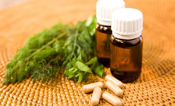 herbs with essential oil bottles and supplements