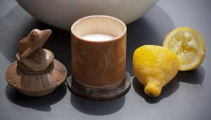 container of salt next to halved lemon