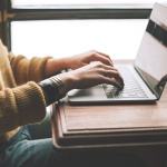 woman typing on laptop computer