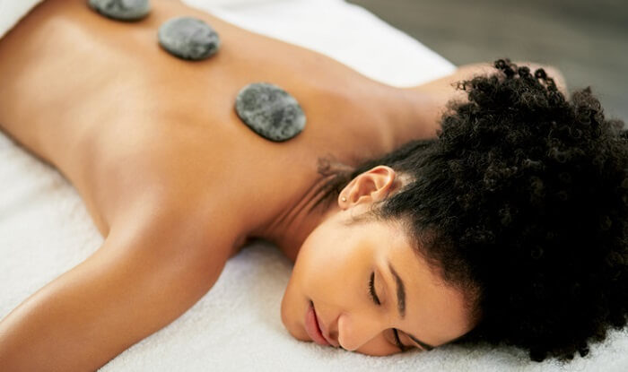 young woman getting a hot stone massage