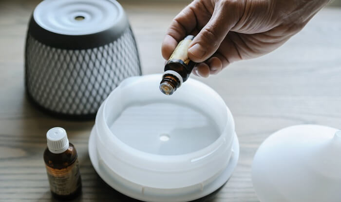 adding essential oils to a diffuser