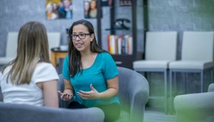 woman conversing with female client in office