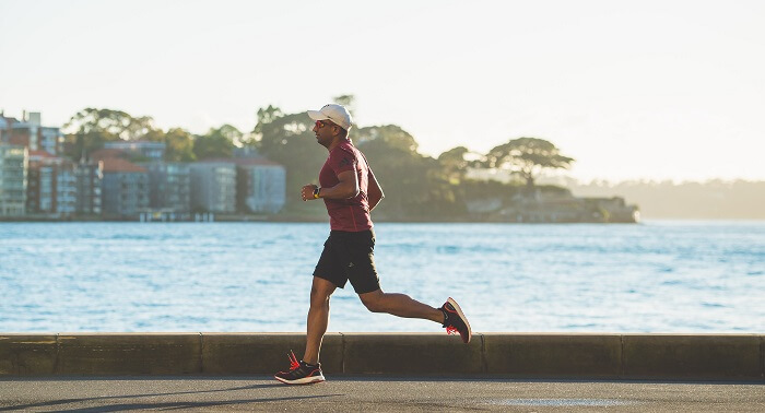 man running next to the beach