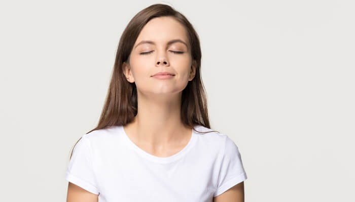 young woman practicing mindful breathing