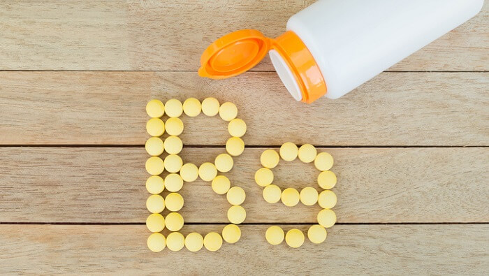 best vitamins for stress - bottle and b9 pills in shape of b9