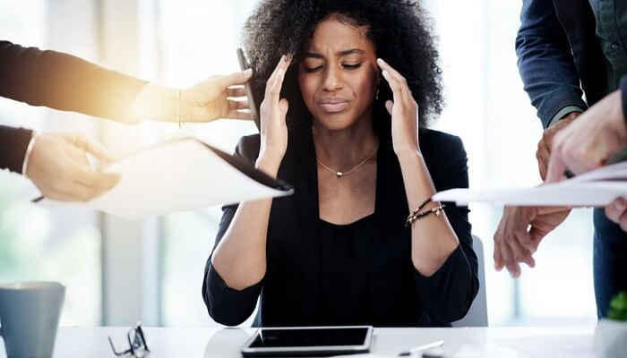 young businesswoman overwhelmed at work