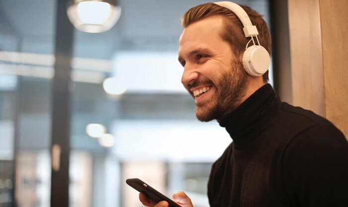man wearing white headphones to reduce noise pollution in office