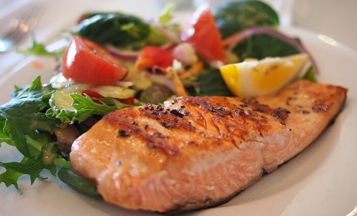 salmon and salad on dinner plate
