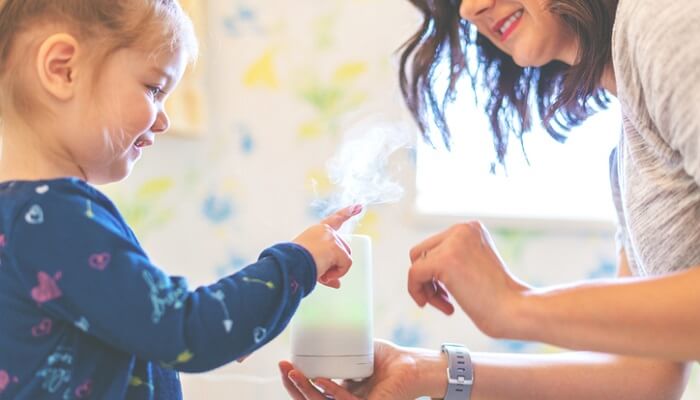 essential oils for adhd concept - child and mother holding diffuser
