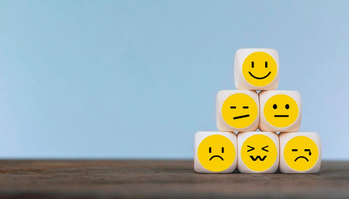 emoticon faces on stacked wooden cubes