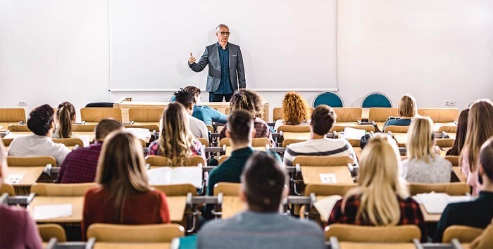 teacher in front of students in classroom