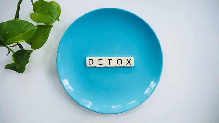 detox in scrabble tiles on blue dinner plate