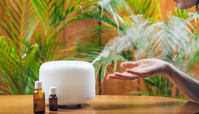diffuser and essential oils on table