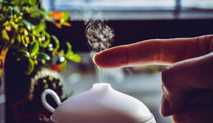 finger over essential oil diffuser