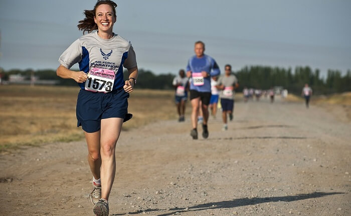 smiling woman running in marathon