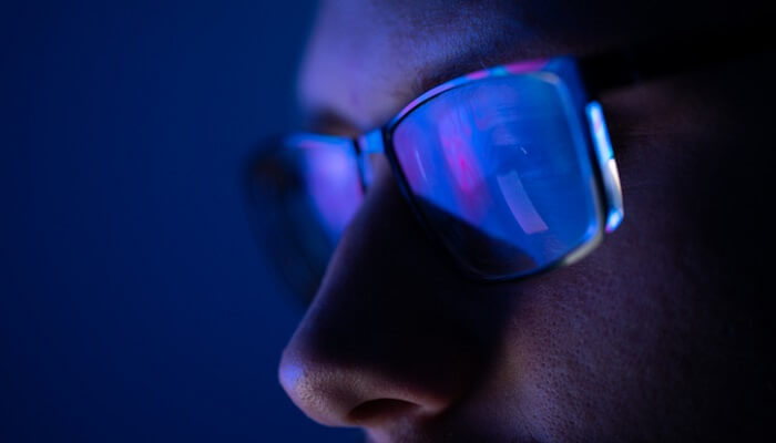 close up of man wearing blue light glasses
