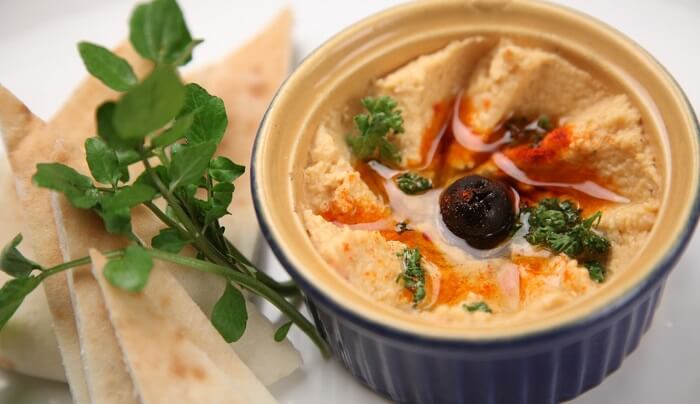 hummus with pita chips and garnish
