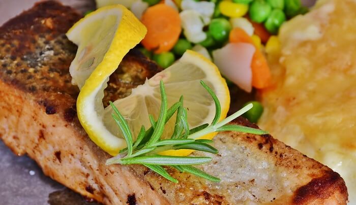 salmon with lemon wedge and thyme