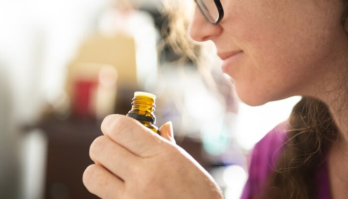 woman enjoying essential oil aromatherapy