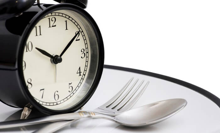 fast to reverse aging concept - alarm clock on dinner plate