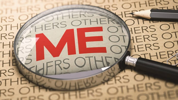 magnifying glass over the word me - egoistic concept