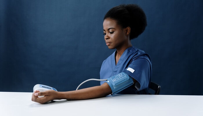 young woman getting blood pressure tested