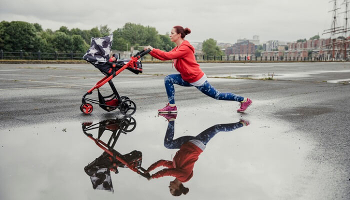 woman with stroller doing lunges