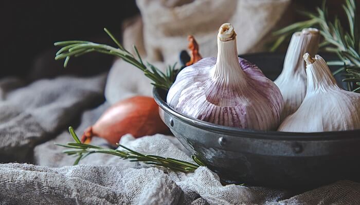 garlic and thyme in rustic bowl