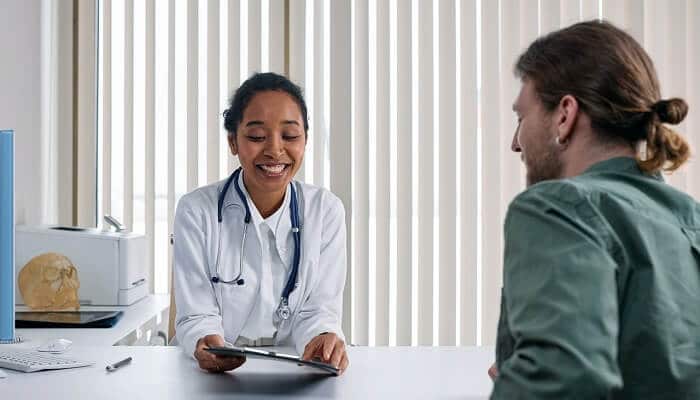 smiling doctor consulting patient