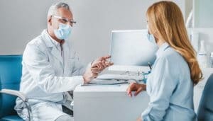 male practitioner consulting female client in office