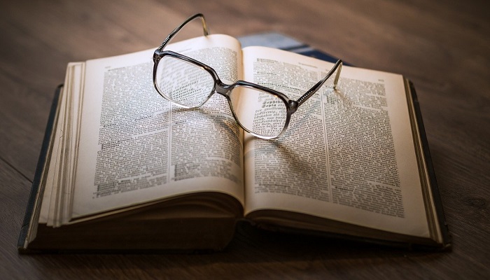 glasses on open book