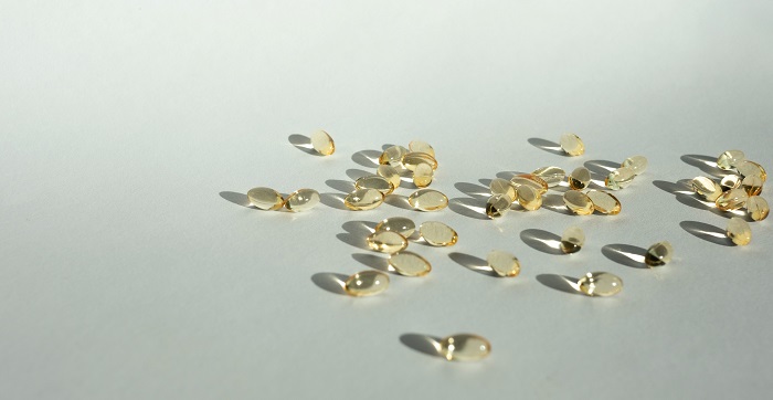 vitamin d pills on white background