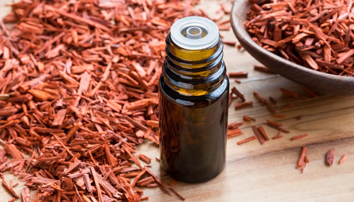 cedarwood chips next to essential oil bottle