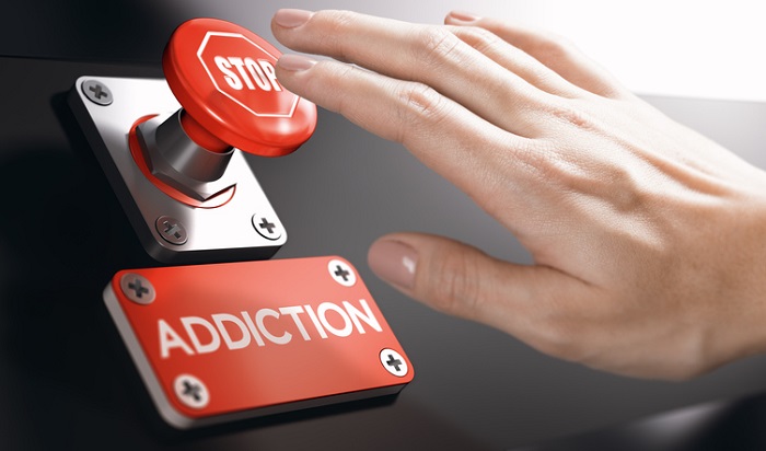 hand pressing stop addiction button
