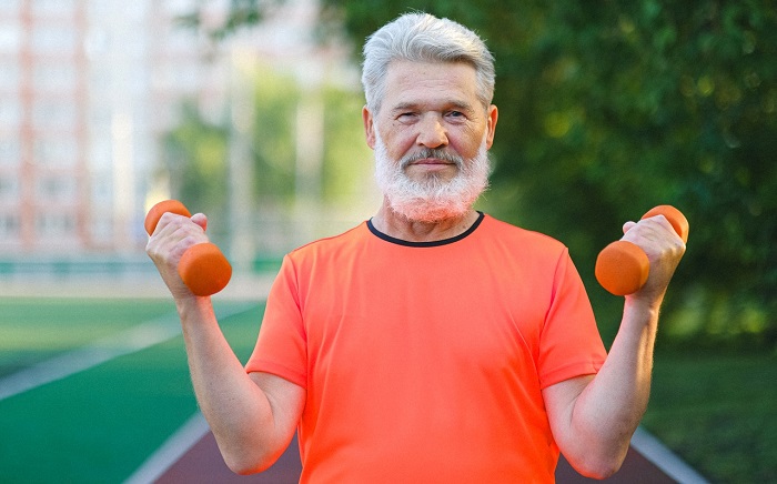 senior man exercising with dumbbells