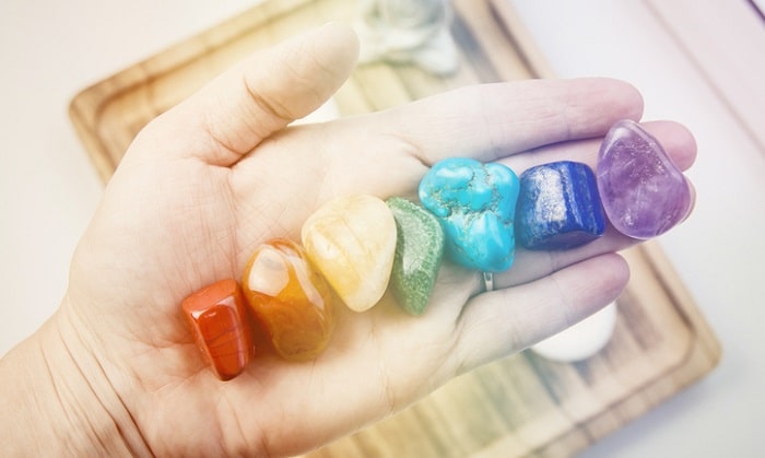 7 chakra stones in hand