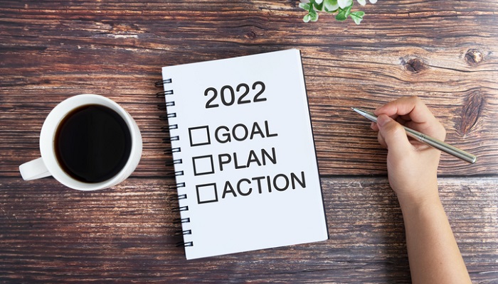 outlining stress management plan with pen and paper