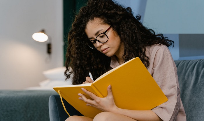woman writing in journal
