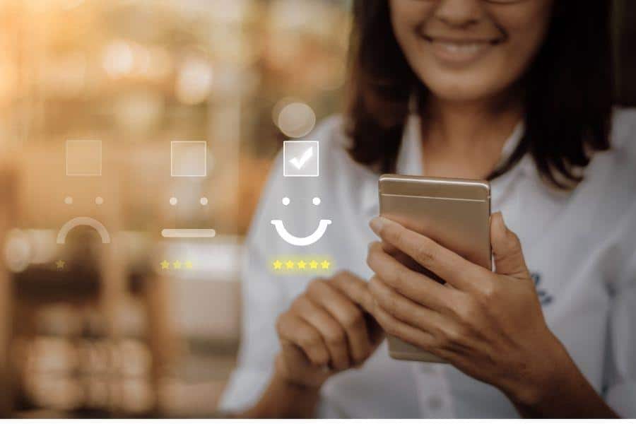 happy woman holding phone giving positive review to business