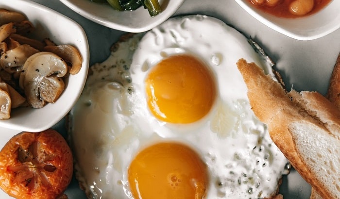 cooked egg with beans and mushroom and greens