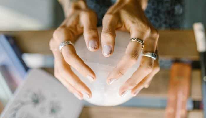 woman holding crystal in hands