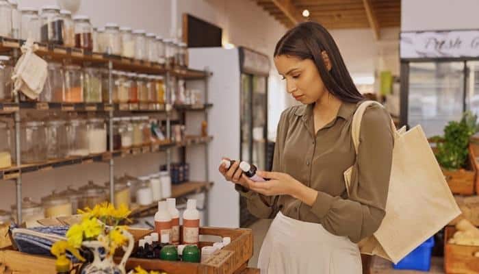 young woman searching for best essential oils in store